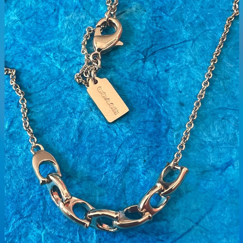 COACH Linked Signature Gold Necklace.